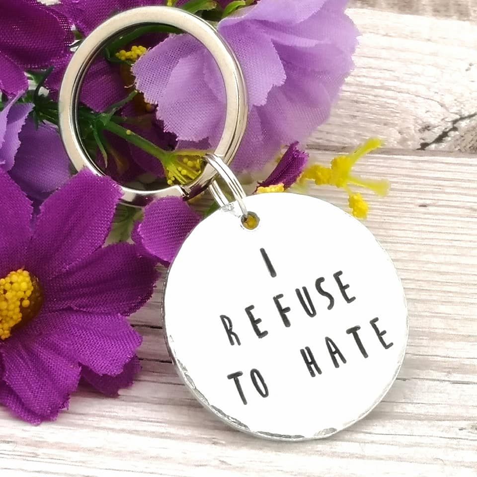 Circular metal keyring with wording I refuse to hate