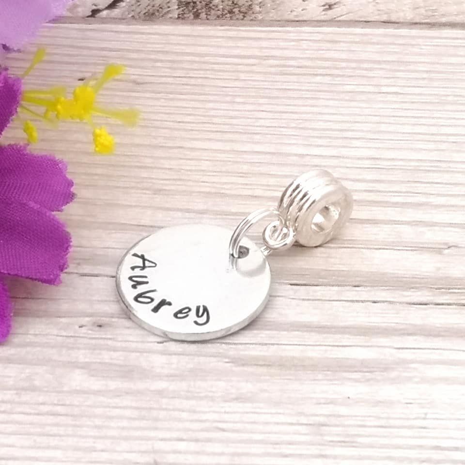 Small bracelet charm. Disc charm, fluted carrier