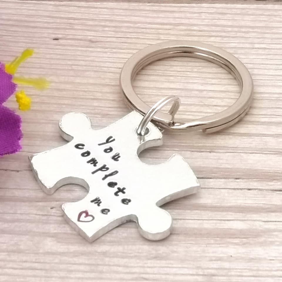 Metal jigsaw piece shaped keyring with wording, You complete me