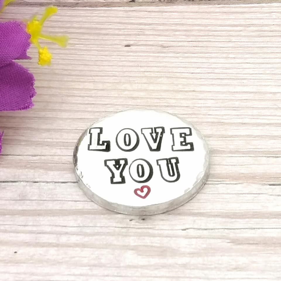 Small chunky metal token with the wording LOVE YOU & small heart