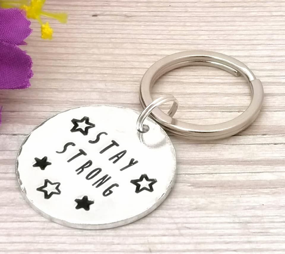 Circular metal keyring with wording Stay Strong & stars