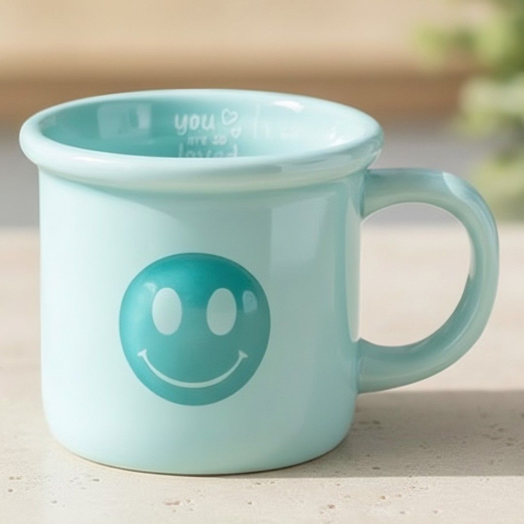 Blue smiley face mug styled on a cosy kitchen surface