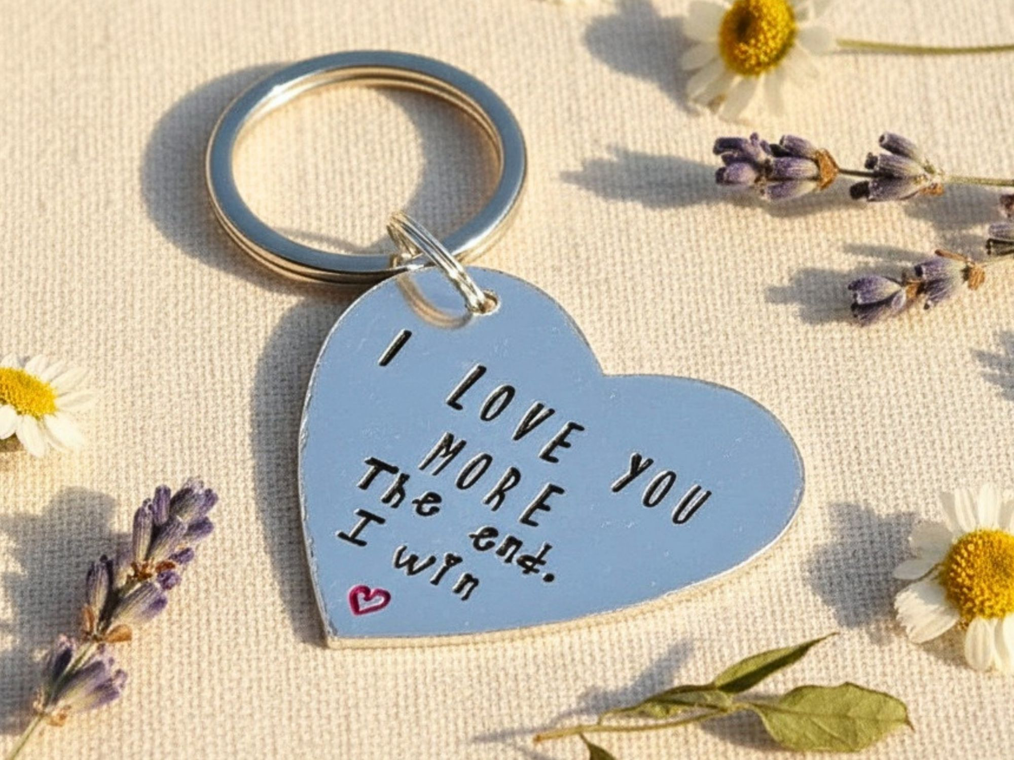 Hand stamped aluminium "I Love You More" heart keyring for couples