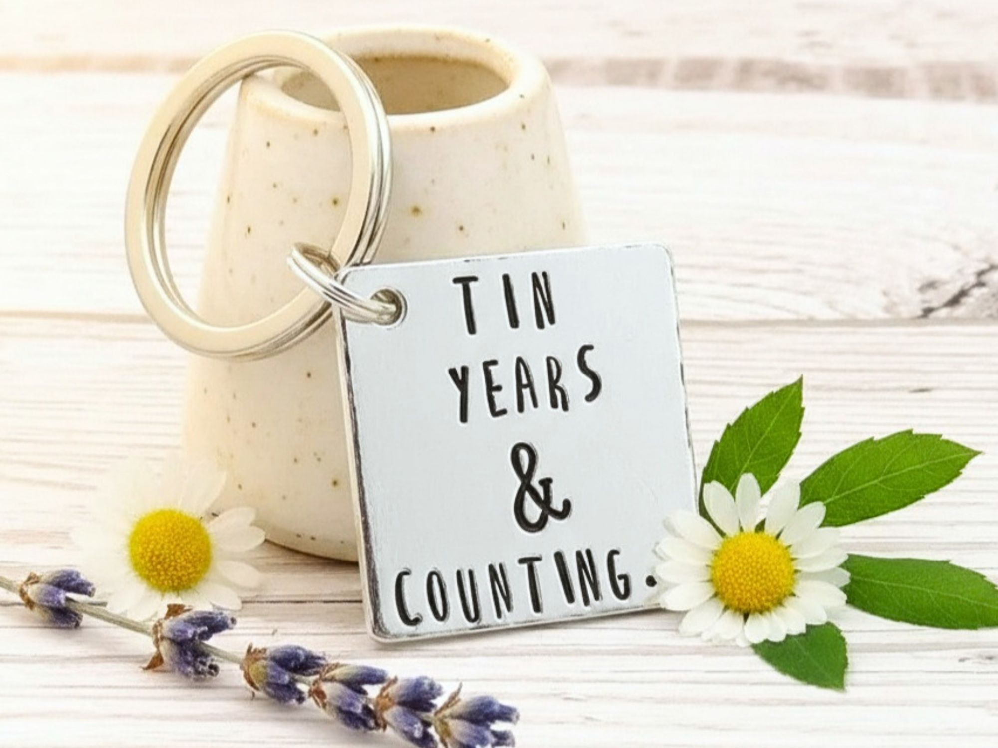 Hand stamped aluminium 10th anniversary keyring with "Tin Years & Counting" design