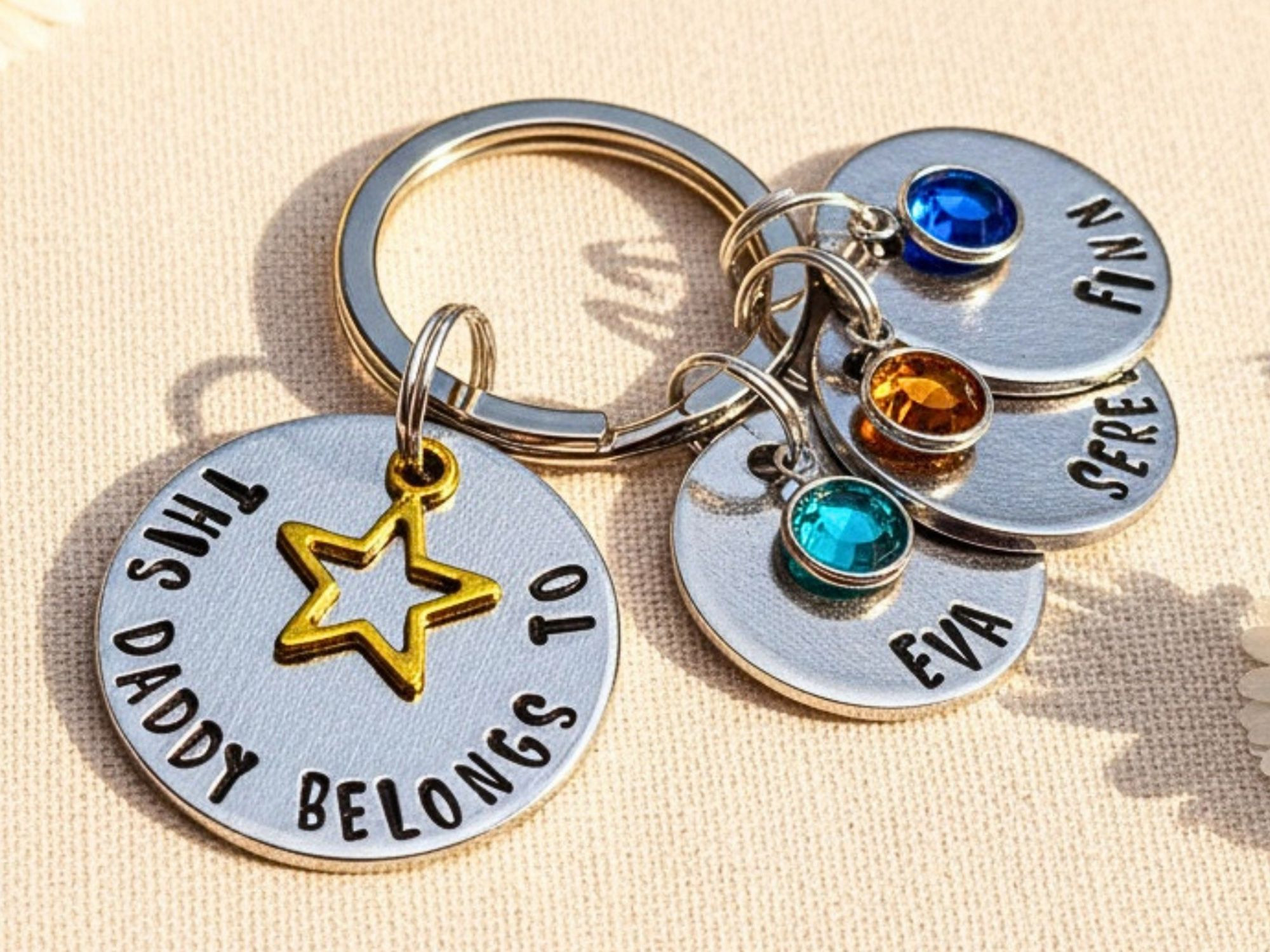 Hand stamped aluminium "This Daddy Belongs To" keyring with star charm and birthstone crystals