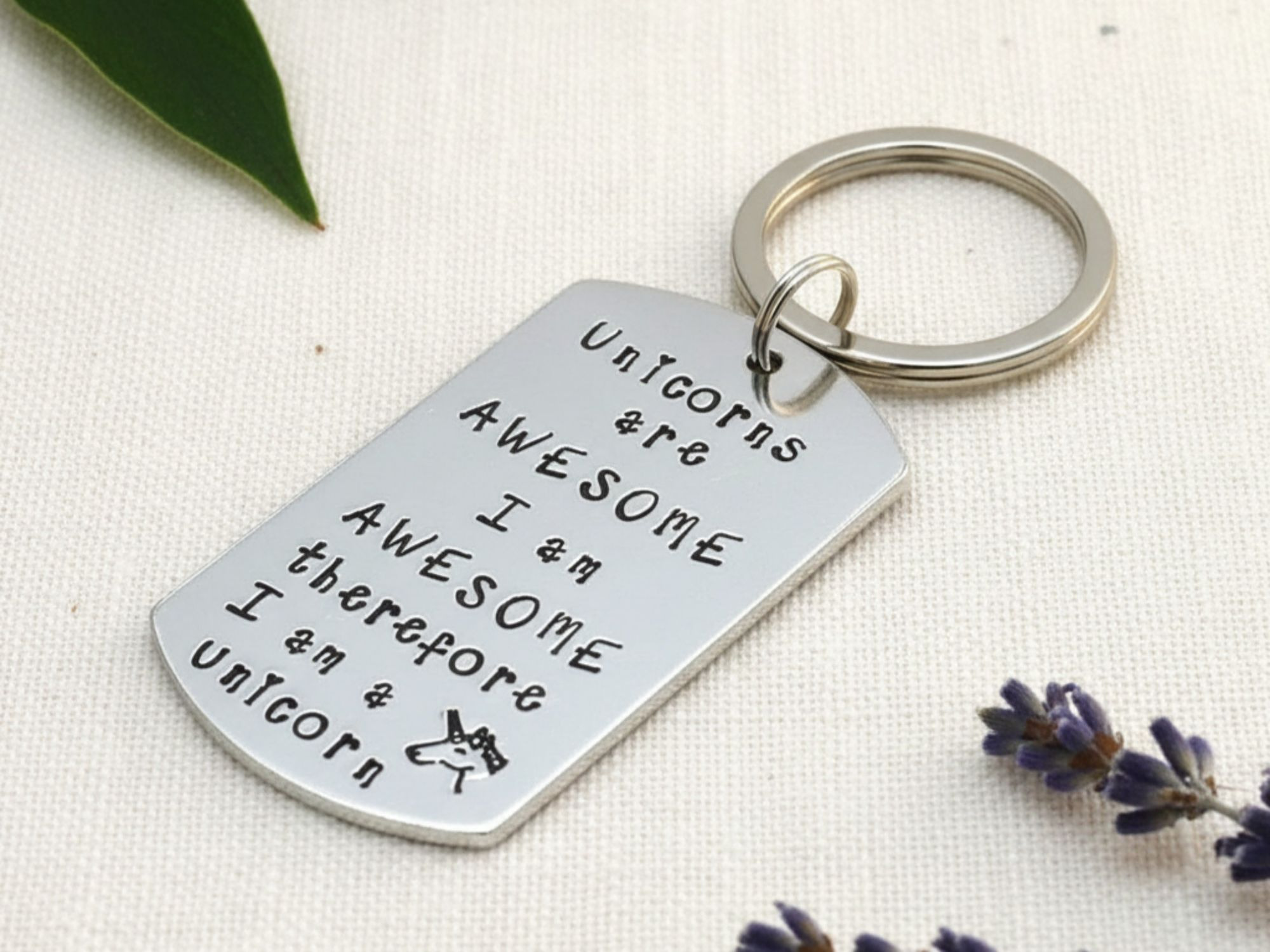 Hand stamped aluminium unicorn keyring with "Unicorns Are Awesome" design