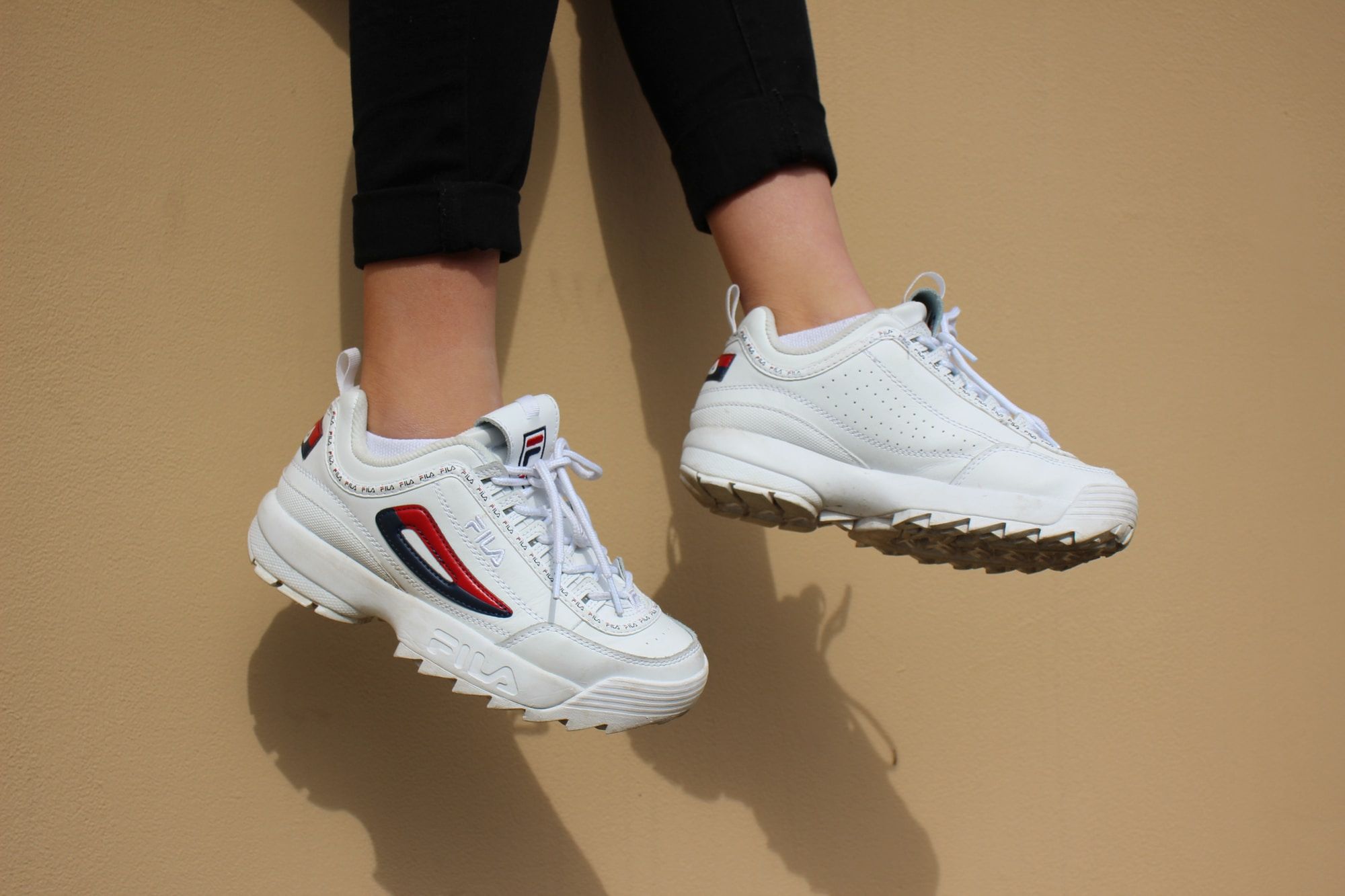 A pair of white Fila trainers