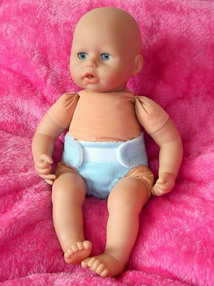 Doll wearing a blue nappy