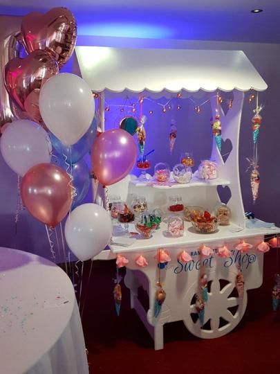 Sweet Cart Candy Cart decorated with lights and rose gold Balloon Cluster