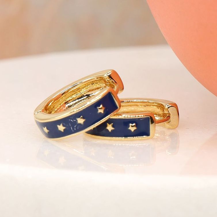 Golden huggie hoop earrings with stars and navy enamel