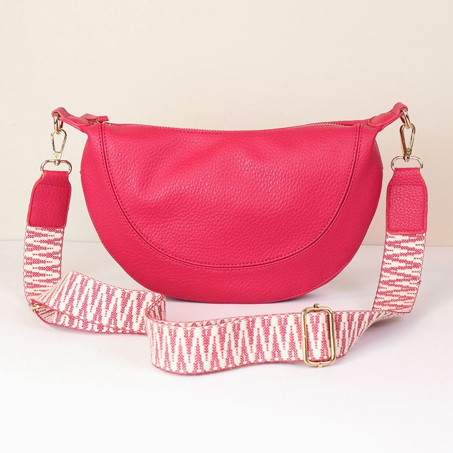 Pink vegan leather half moon bag with zig-zag strap