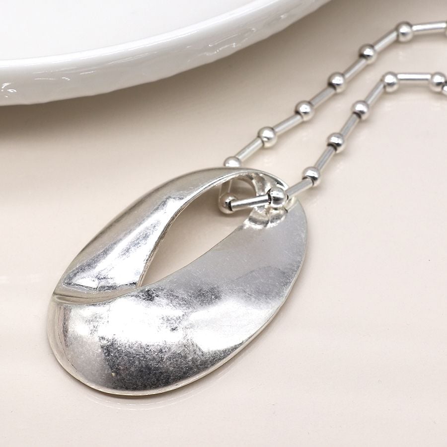 Silver plated station and worn oval necklace