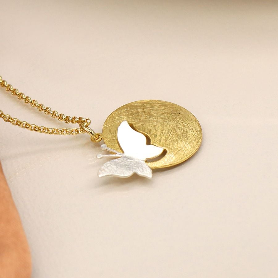 Golden scratched disc and silver plated cut butterfly necklace