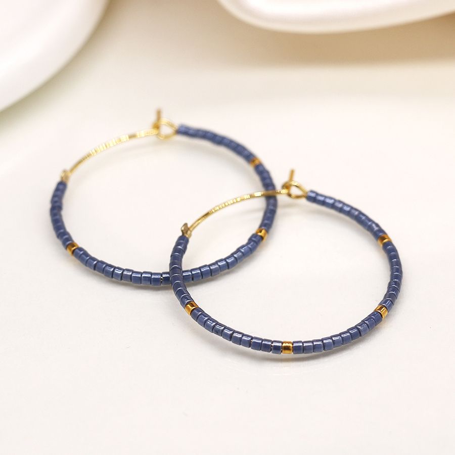 Faux gold open hoop and blue bead earrings