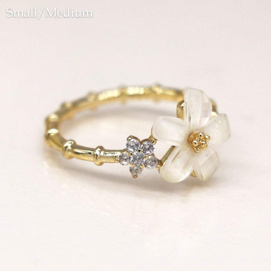 Gold plated sectional ring with white and crystal flowers m/l