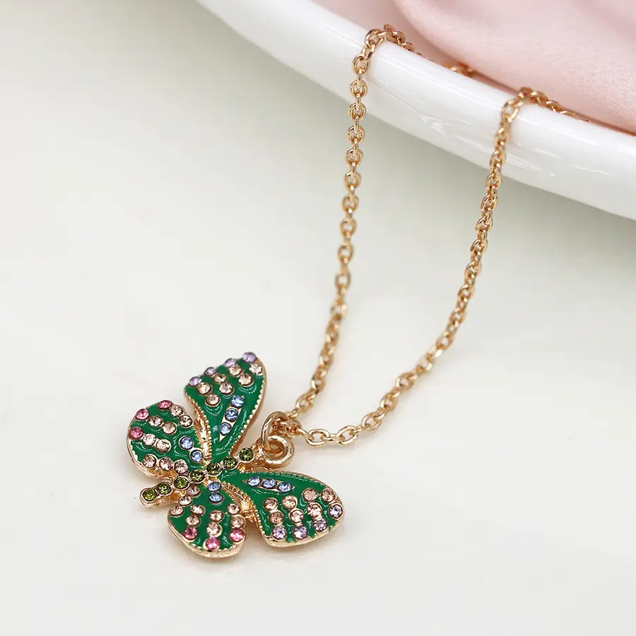 Faux gold plated green enamel and crystal butterfly necklace