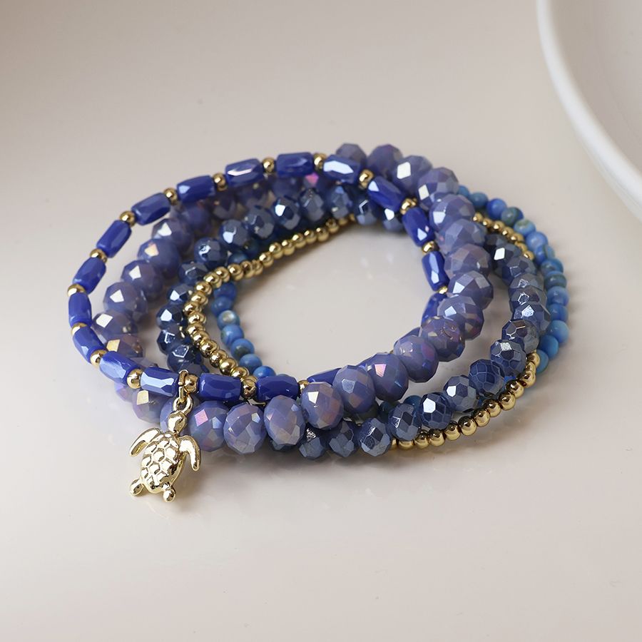 Blue and gold bead bracelet stack with sea turtle