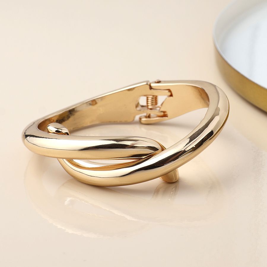 Golden crossover hinged bangle