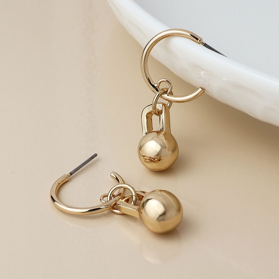 Golden c-hoop and ball charm earrings