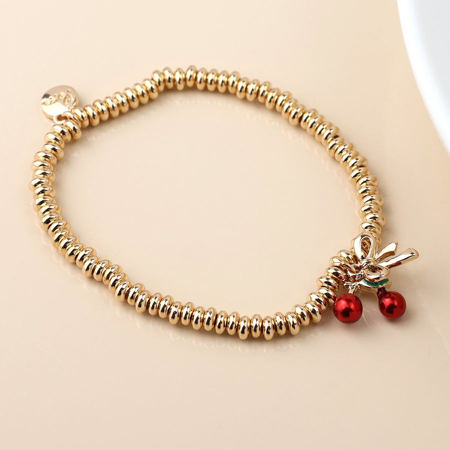 Golden bow and cherries charm bracelet