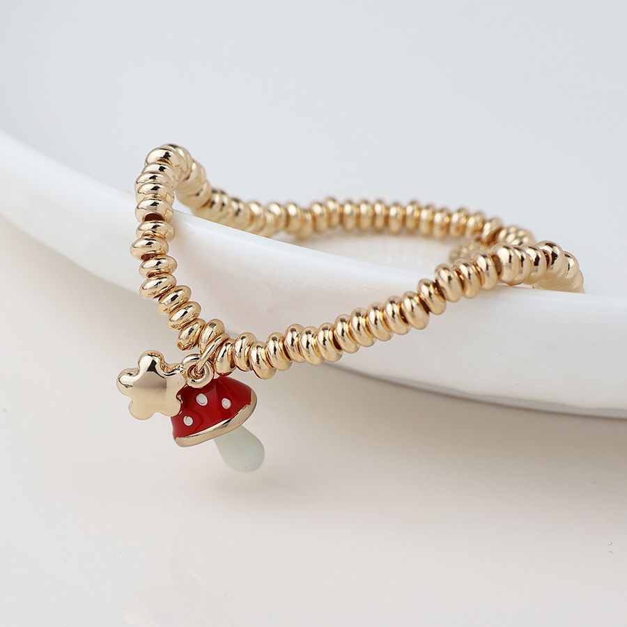 Golden flower and toadstool charm bracelet