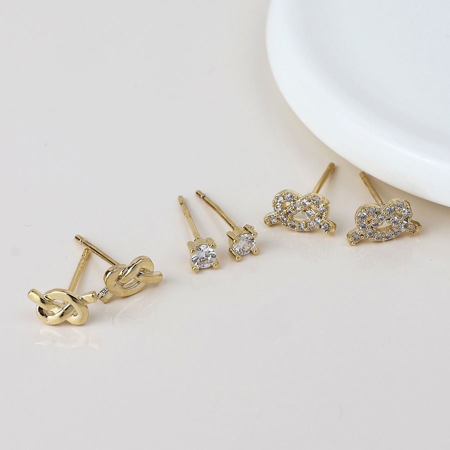 Golden knots and crystal triple stud earring set