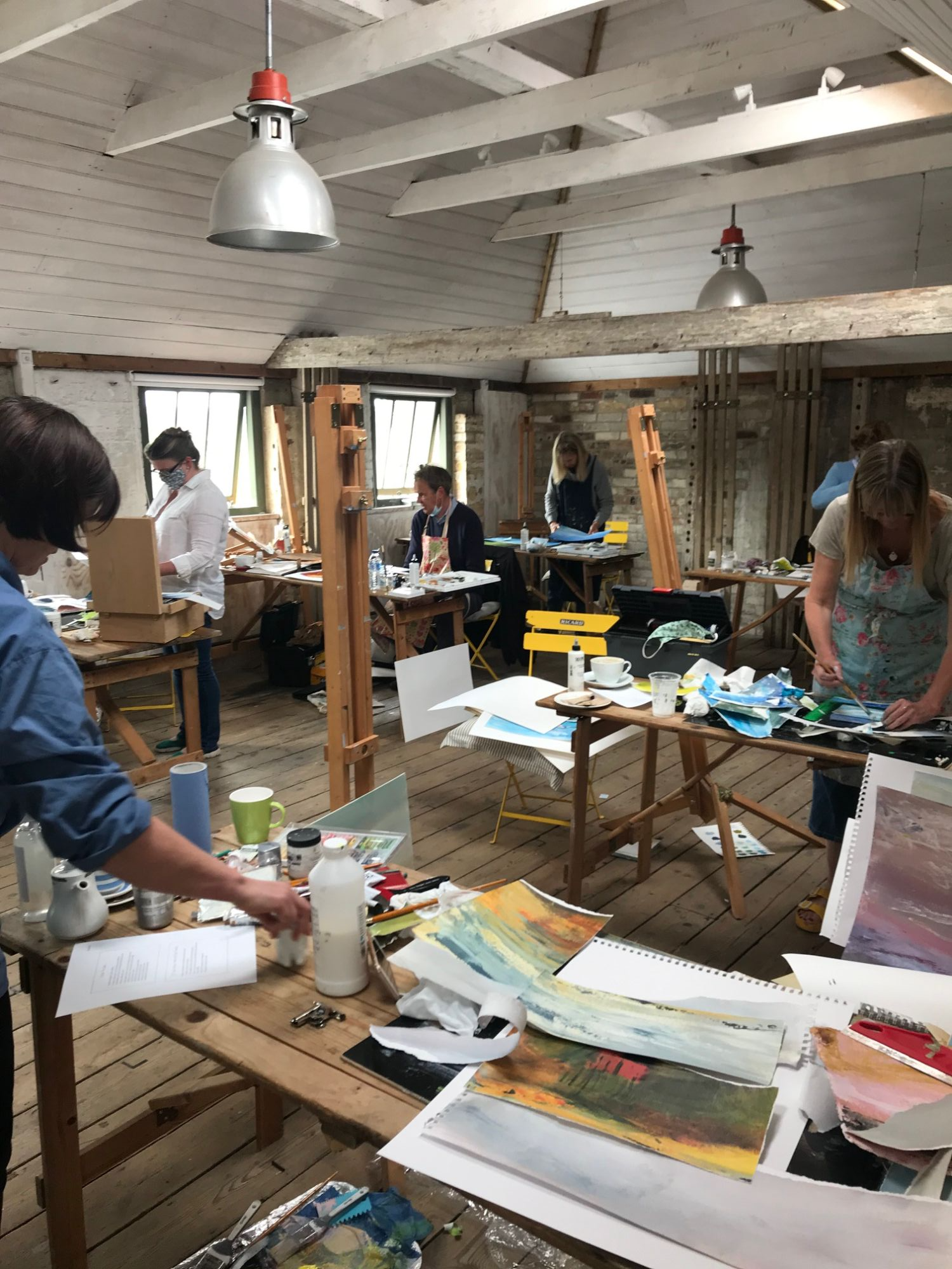 group of students painting in workshop