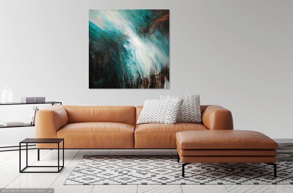 Abstract seascape on wall above tan leather sofa