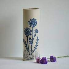 Cream vase with blue flowers