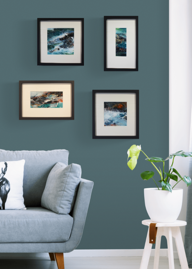 Framed seascapes on wall with sofa