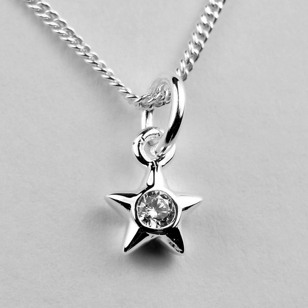 Dainty sterling silver 5mm star pendant with Cubic Zirconia stone, on either a 16" or 18" fine curb chain, in a gift box, with silver polishing cloth