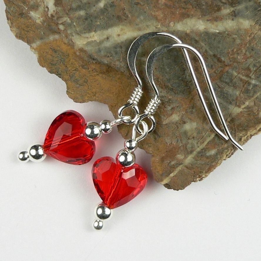 Sterling silver earrings made with 8mm faceted red Swarovski Elements crystal hearts, in a gift box