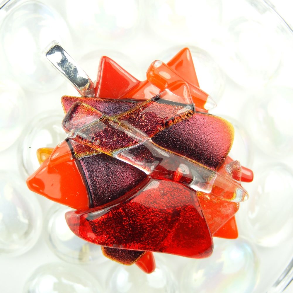 shades of red textured Dichroic glass pendant, with leather cord