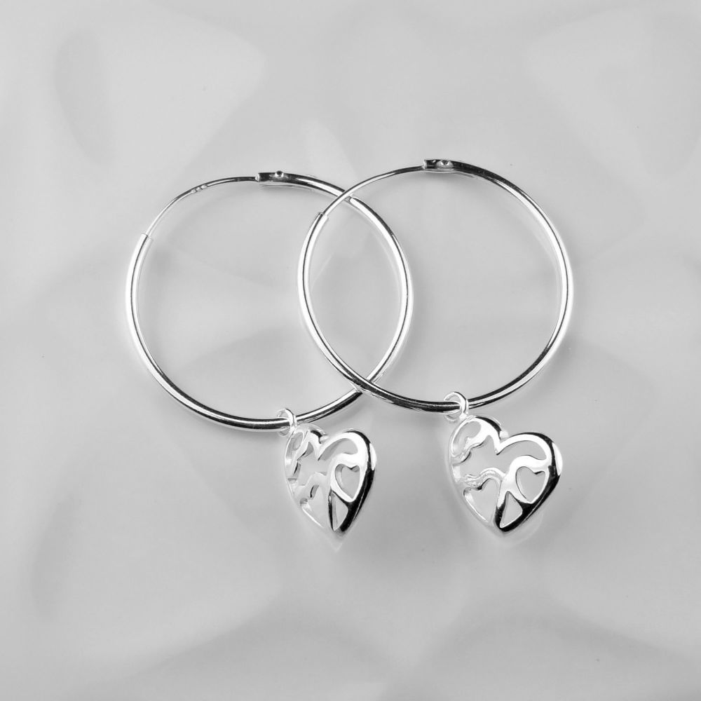 Sterling silver 24mm hoop earrings with 12mm multi hearts on their side, in a gift box