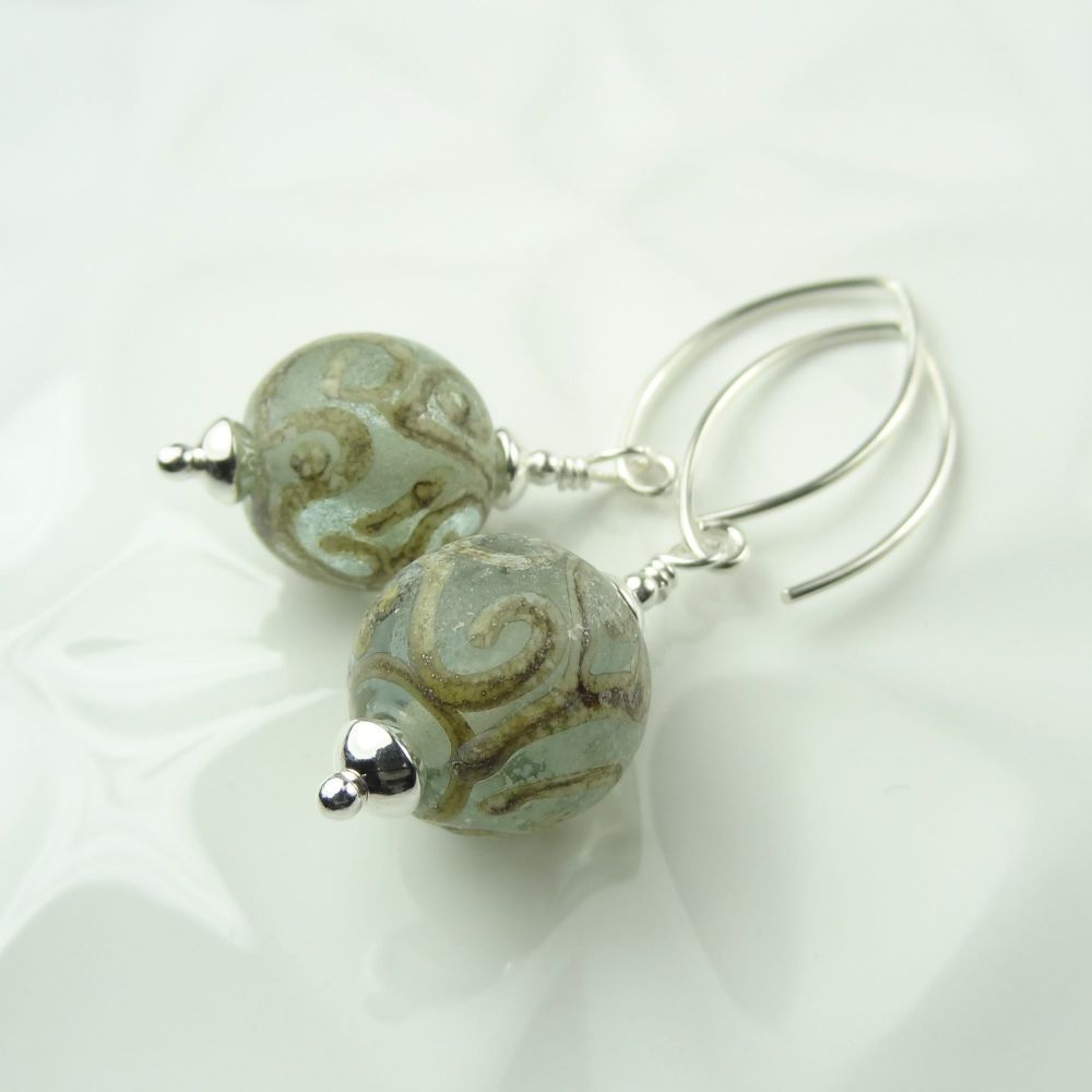 Pale green with silvered ivory scrolls handcrafted artisan lampwork glass & sterling silver earrings on 'V' wires ~ UK made ~ length 47mm