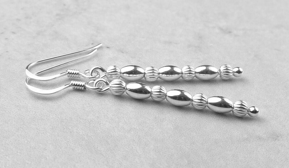 Sterling silver earrings with smooth ovals and fluted round beads - 3x4.6mm ovals/3mm fluted round, silver polishing cloth (#30583)