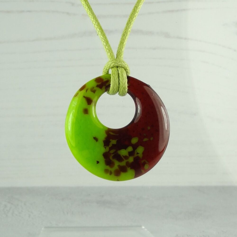 Handcrafted green fused glass off-set round pendant on a waxed cotton cord