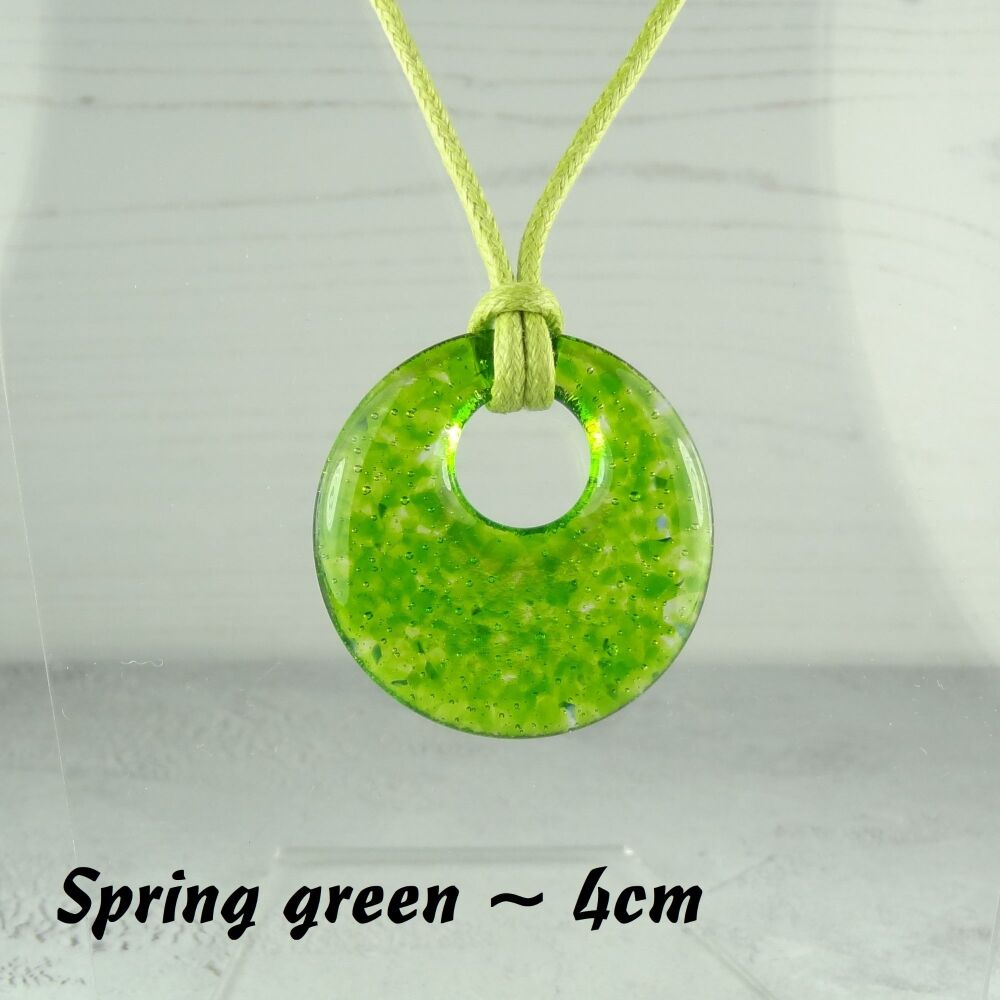 Handcrafted spring green fused glass off-set round pendant on a waxed cotton cord with lobster clasp (#26)