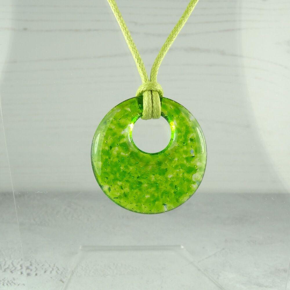 Handcrafted spring green fused glass off-set round pendant on a waxed cotton cord with lobster clasp (#26)