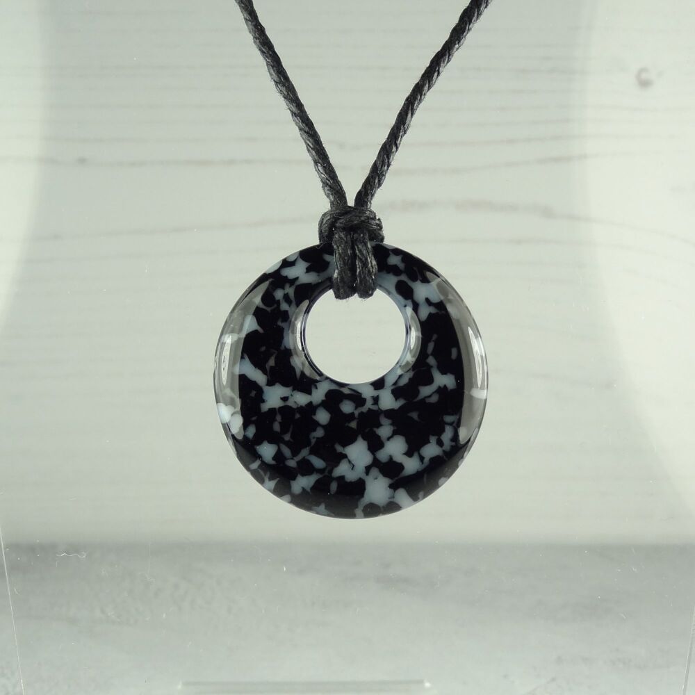 Handcrafted black & white fused glass off-set round pendant on a waxed cord