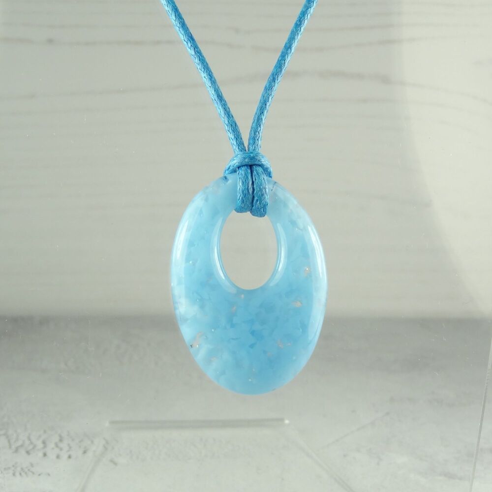 Handcrafted powder blue fused glass off-set oval pendant on a waxed cord