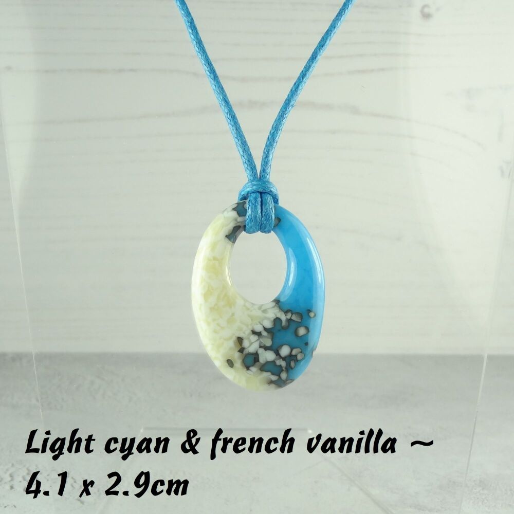 Handcrafted light cyan & french vanilla fused glass off-set oval pendant on a waxed cotton cord with lobster clasp (#32)