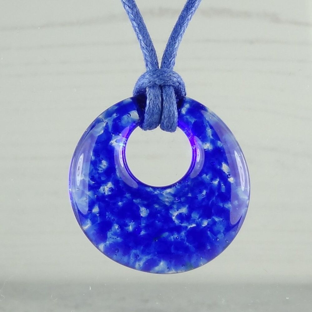 Handcrafted royal blue fused glass off-set round pendant on a waxed cord