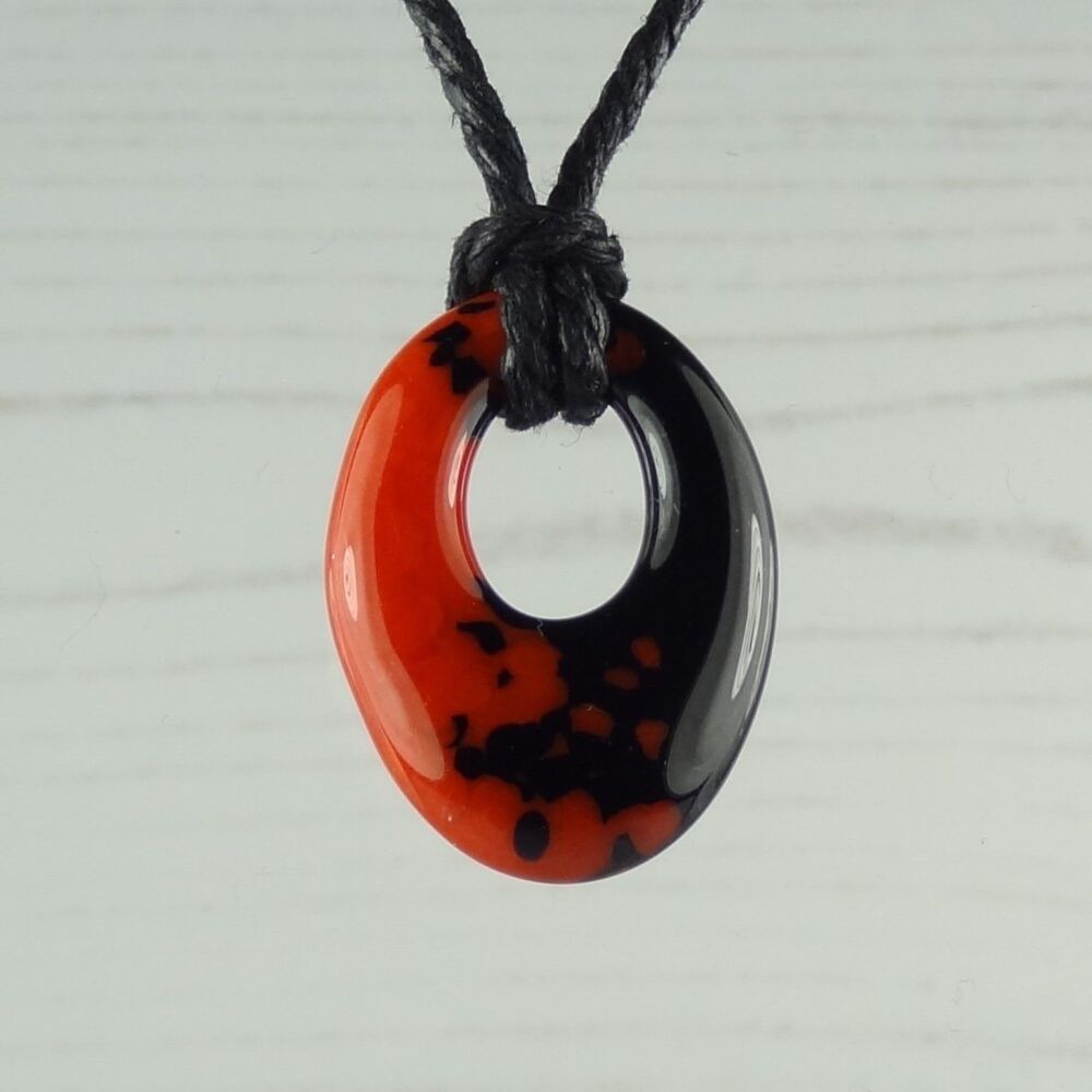 Handcrafted pimento red & blue-black fused glass oval pendant on cord