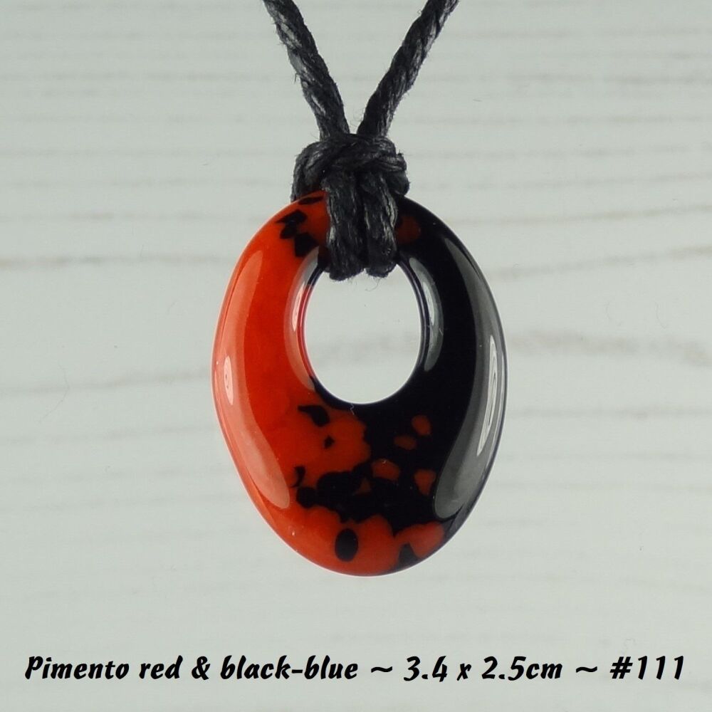 Handcrafted pimento red & black-blue fused glass off-set oval pendant on a waxed cotton cord with lobster clasp (#111)