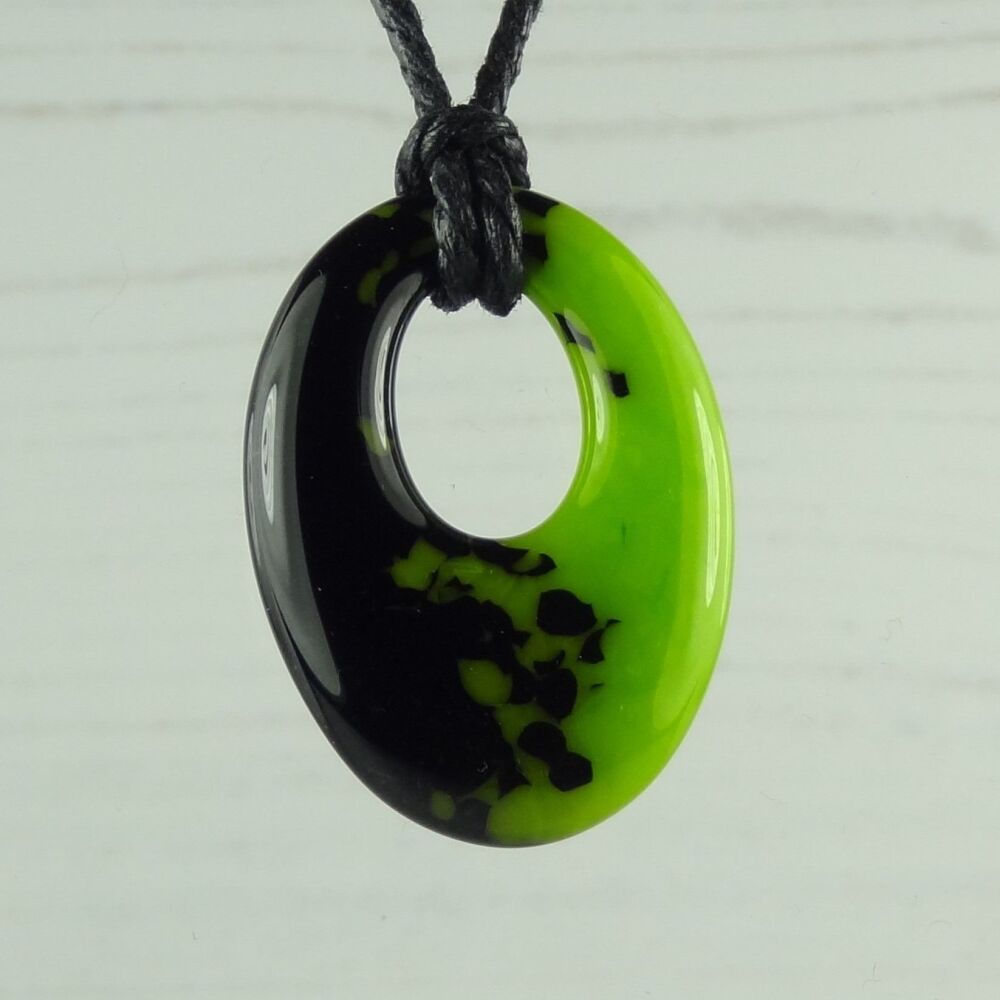 Handcrafted spring green & black-blue fused glass off-set oval pendant on a waxed cotton cord with lobster clasp (#113)