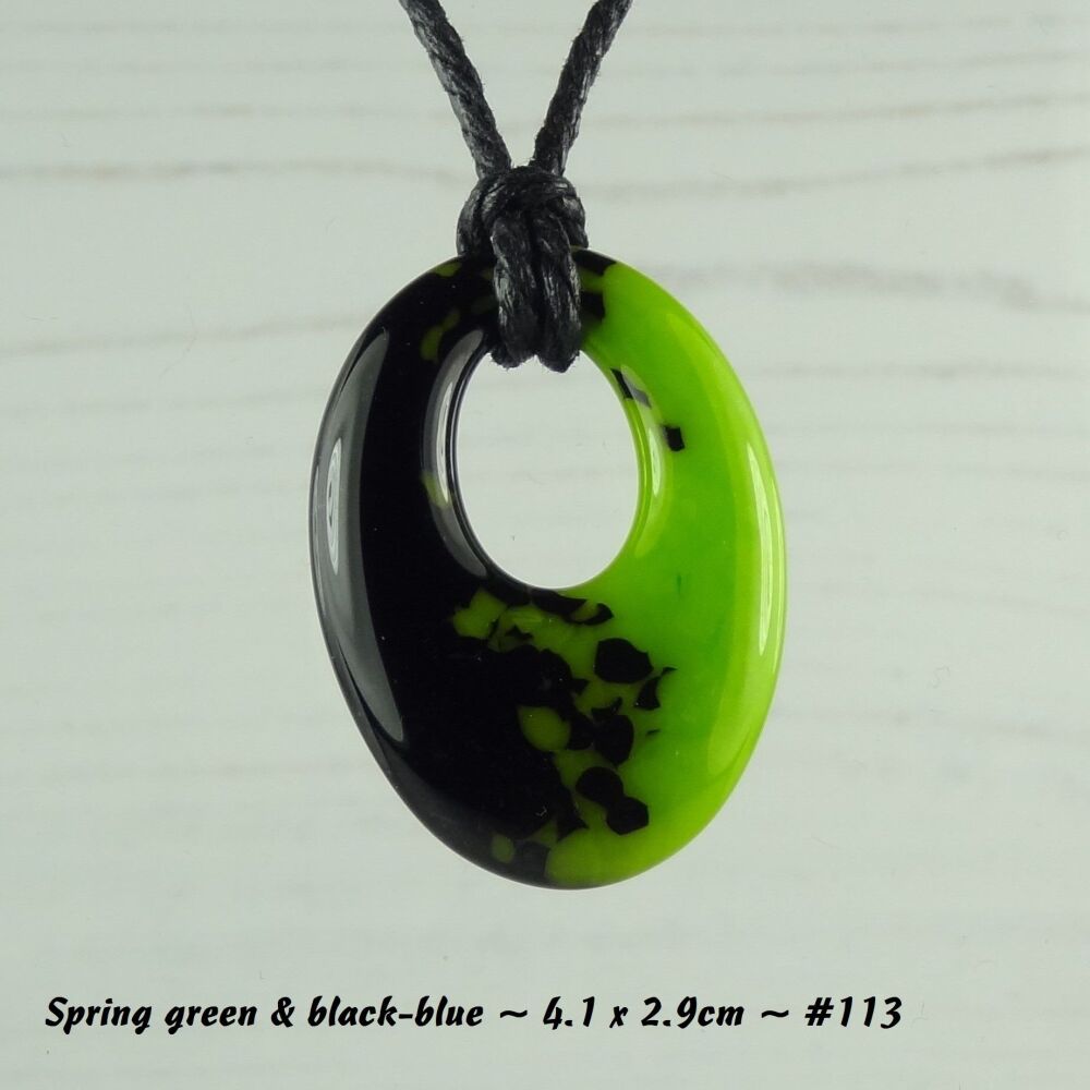 Handcrafted spring green & black-blue fused glass off-set oval pendant on a waxed cotton cord with lobster clasp (#113)