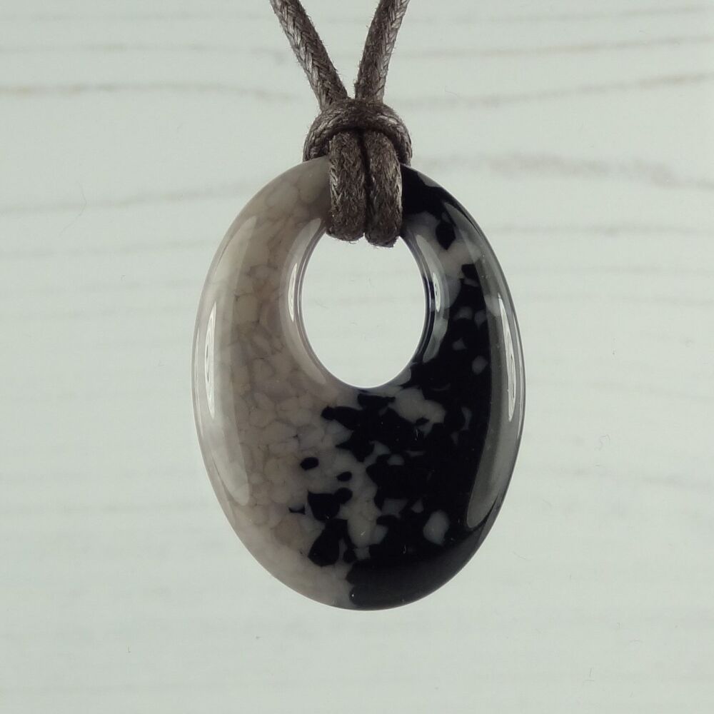 Handcrafted mink & black-blue fused glass oval pendant on a waxed cord