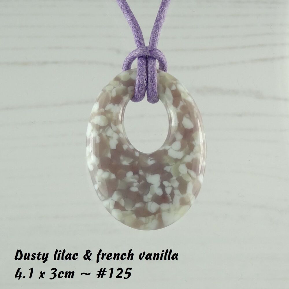 Handcrafted dusty lilac & french vanilla fused glass off-set oval pendant on a waxed cotton cord with lobster clasp (#125)