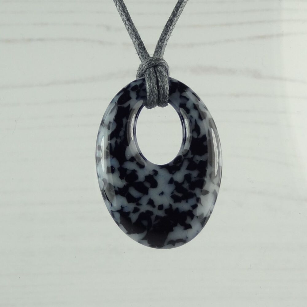 Handcrafted grey & black-blue fused glass oval pendant on a waxed cord